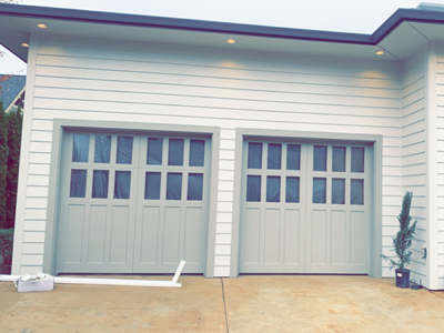 Gutters being installed above a two car garage