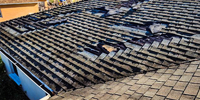 Damaged roof in Portland OR area - call American Mastercraft for roof repair and re-roofing